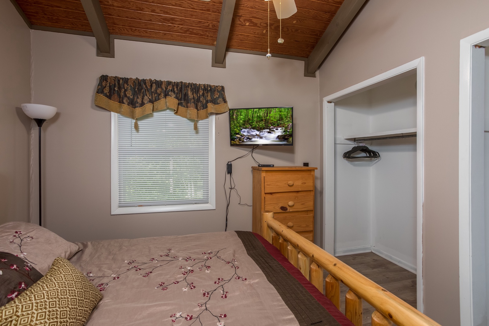 Closet, dresser, and TV in a bedroom at Forever Country, a 3 bedroom cabin rental located in Pigeon Forge