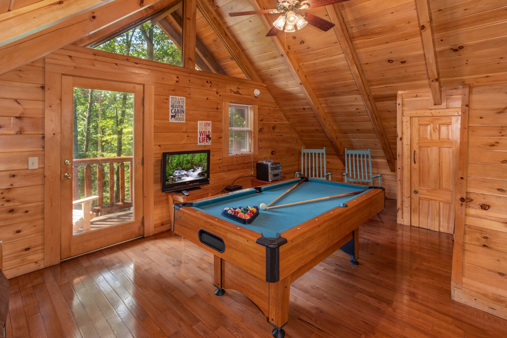Green felted pool table in the game loft at Dreams Do Come True, a 1-bedroom cabin rental located in Pigeon Forge