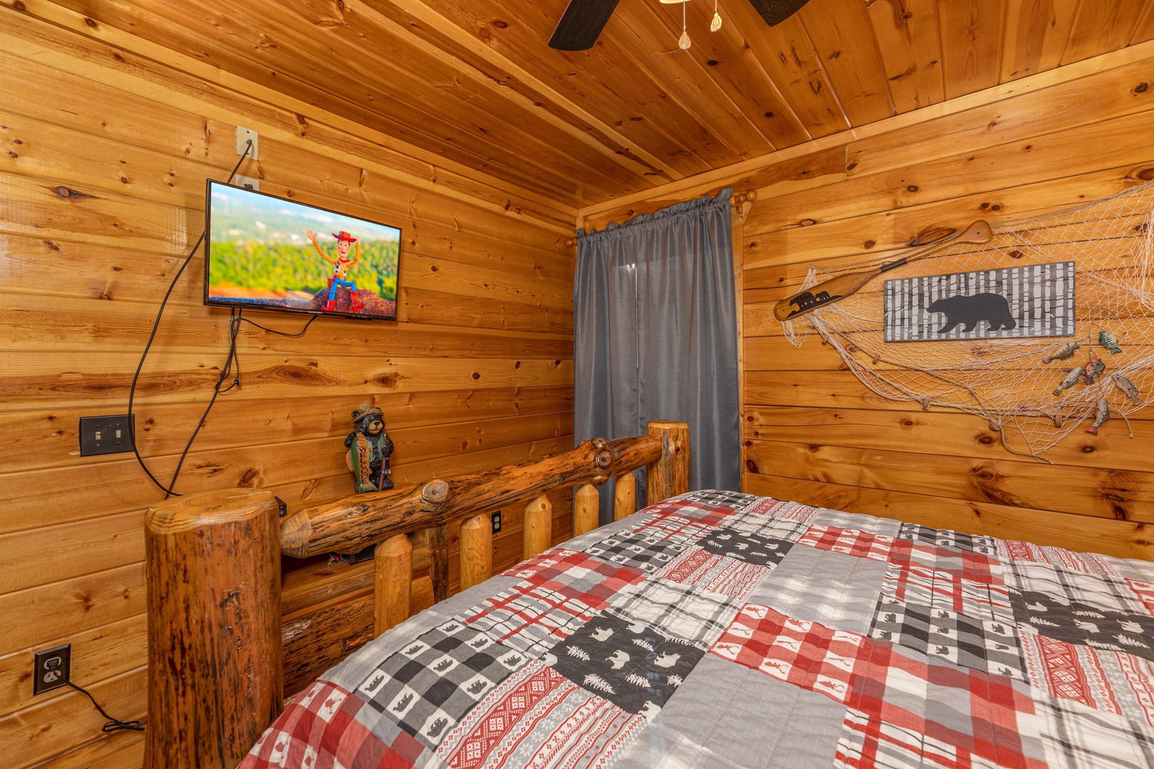 TV and dresser in a bedroom at A Bear on the Ridge, a 2 bedroom cabin rental located in Pigeon Forge