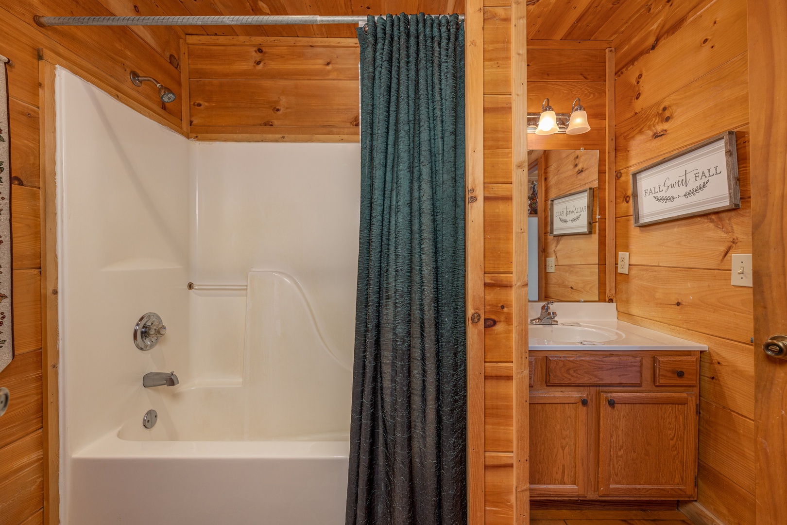Bathroom with a tub and shower at Fallin' in Love, a 1 bedroom cabin rental located in Gatlinburg