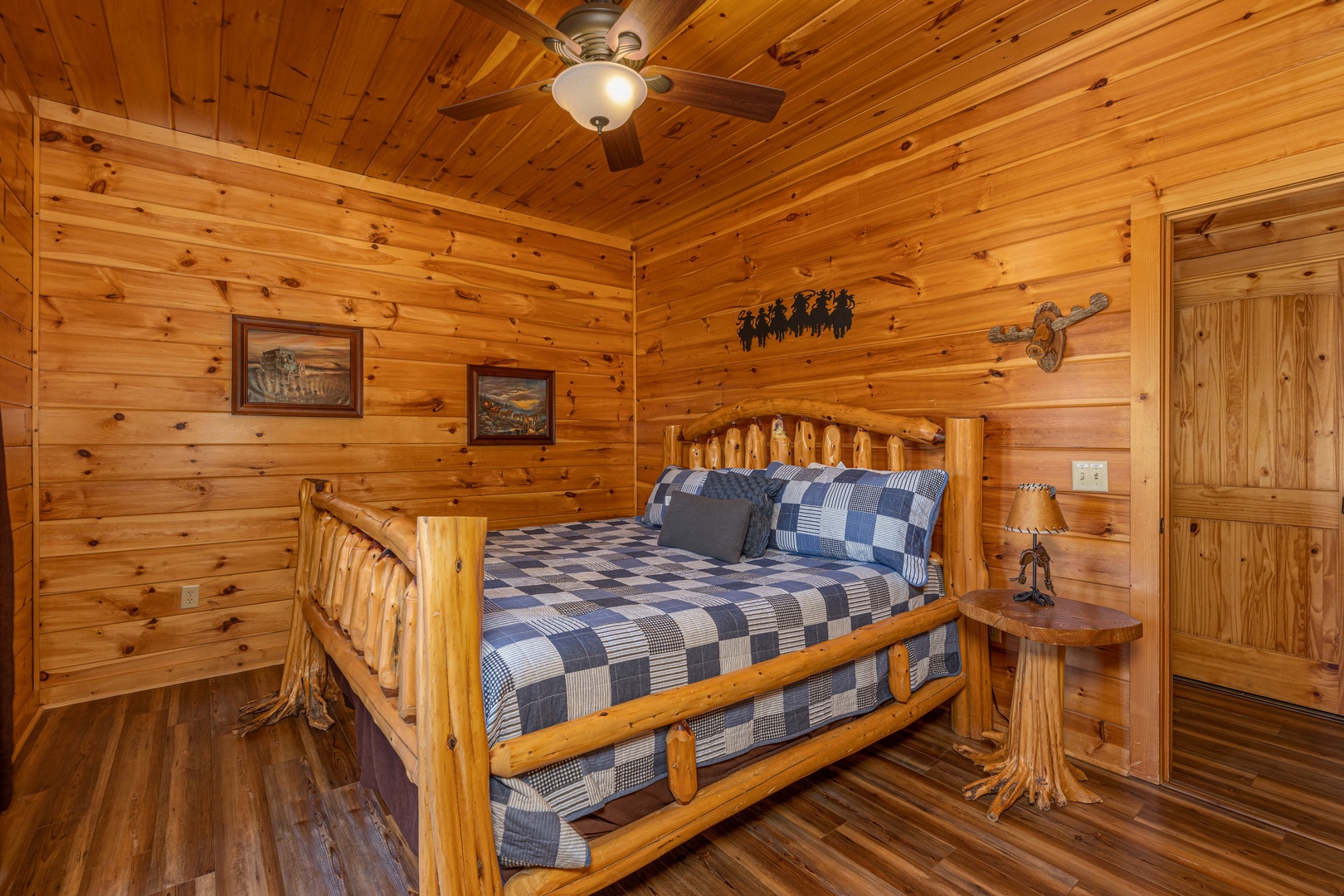 Bedroom with a log bed and night stand at God's Country, a 4 bedroom cabin rental located in Pigeon Forge
