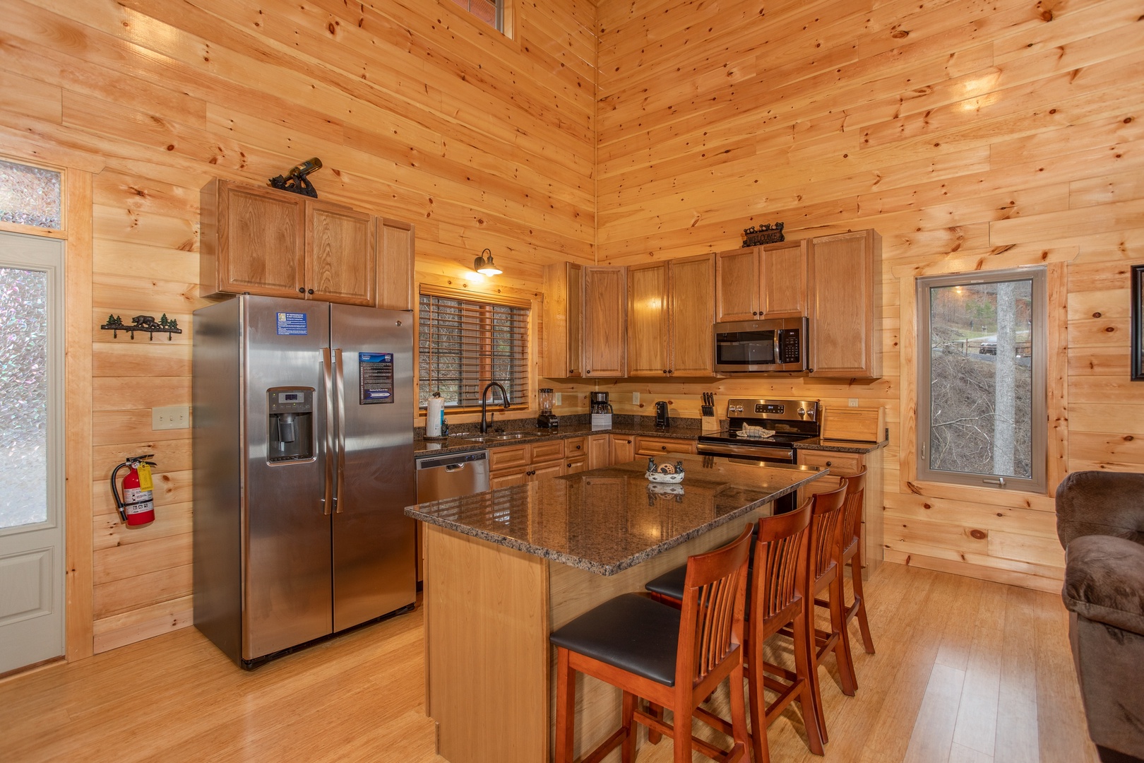 Kitchen with stainless appliances and breakfast bar at Happy Bear's Hideaway, a 2 bedroom cabin rental located in Gatlinburg