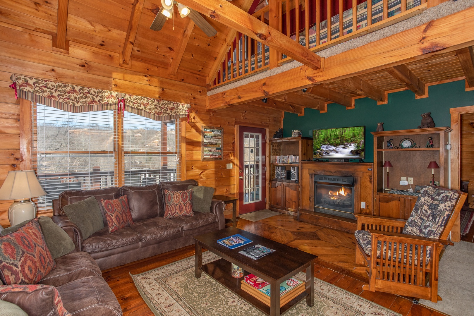 Living room with a fireplace and TV at Shiloh, a 3 bedroom cabin rental located in Gatlinburg