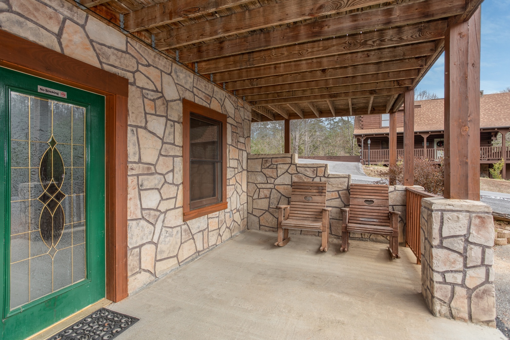 Front porch with two rocking chairs at Hibernation Station, a 3-bedroom cabin rental located in Pigeon Forge