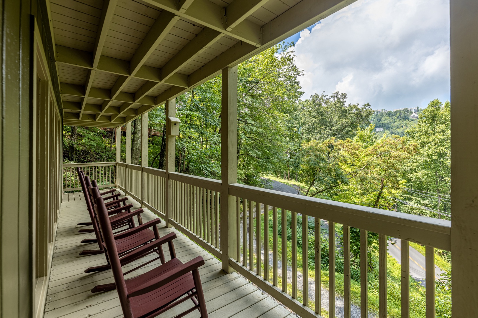 Rocking chairs on a covered deck at License to Chill, a 3 bedroom cabin rental located in Gatlinburg
