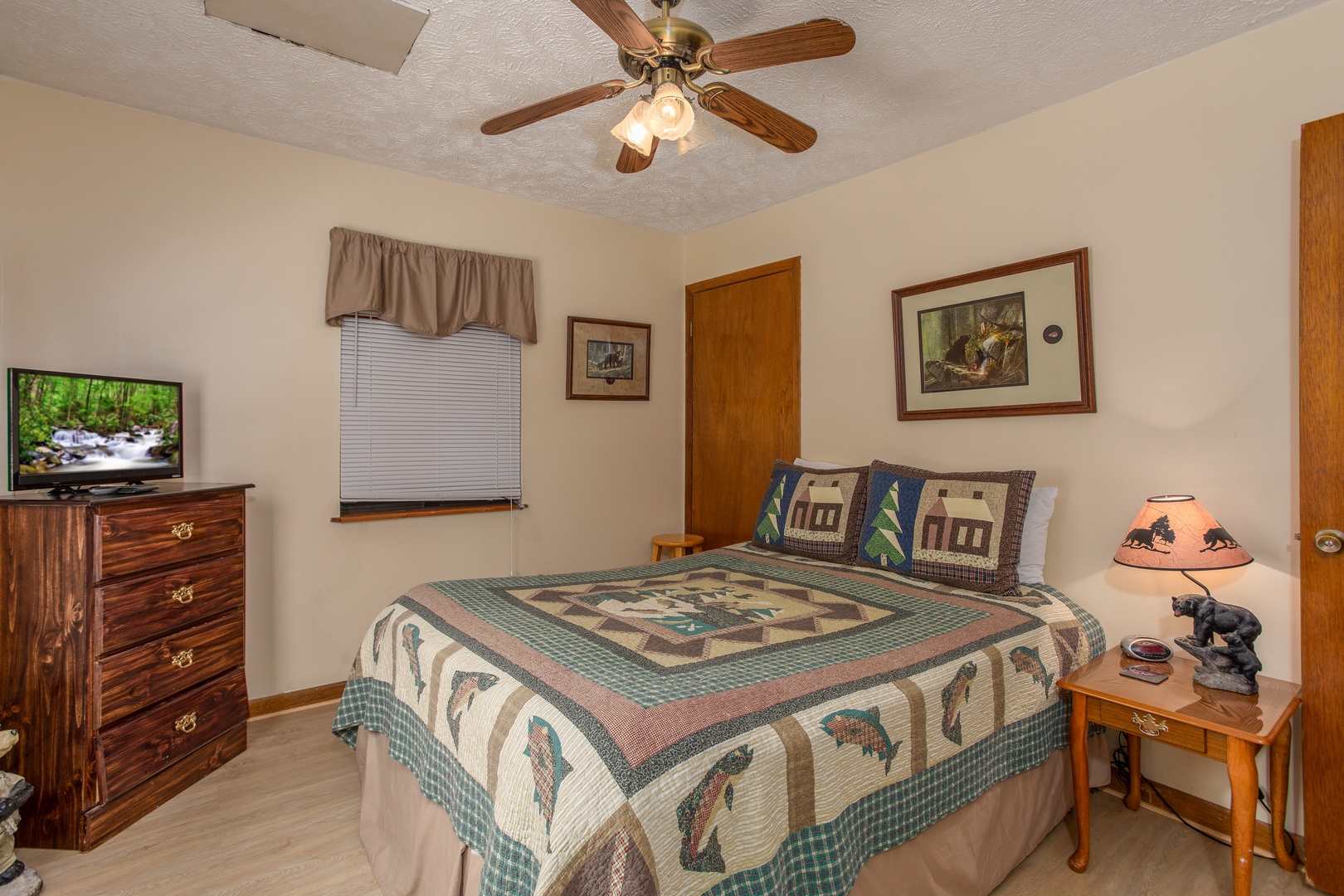 Bedroom with a dresser and fireplace at Black Bear Ridge, a 3-bedroom cabin rental located in Pigeon Forge