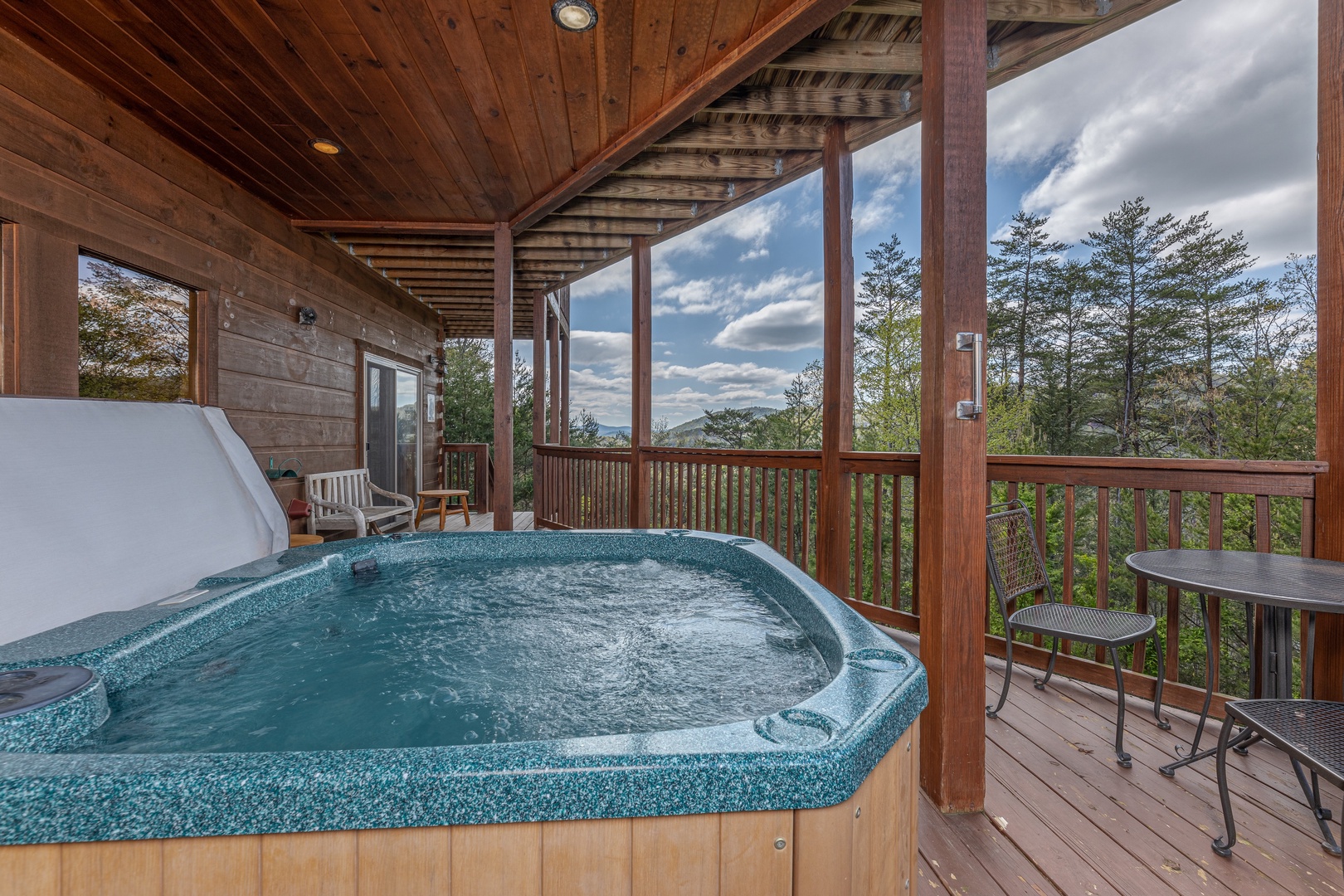 Hot tub and seating at Mountain Laurel Lodge, a 4 bedroom cabin rental located in Pigeon Forge