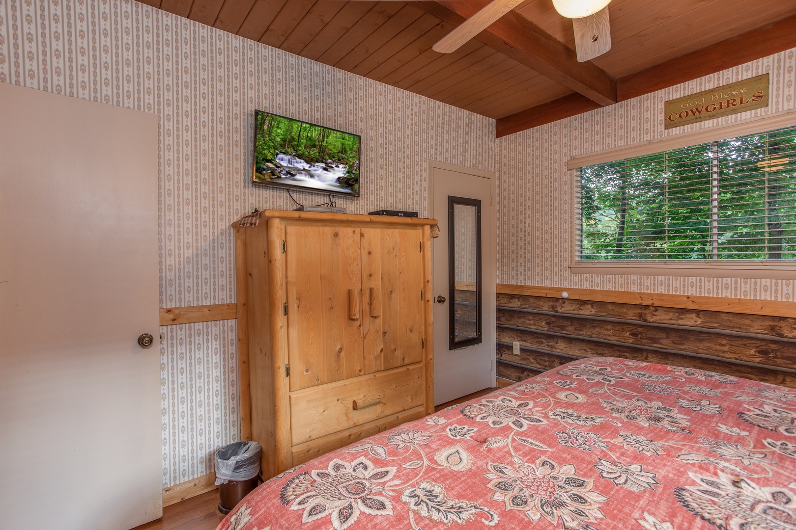 Second bedroom with a television and armoire at Bushwood Lodge, a 3-bedroom cabin rental located in Gatlinburg