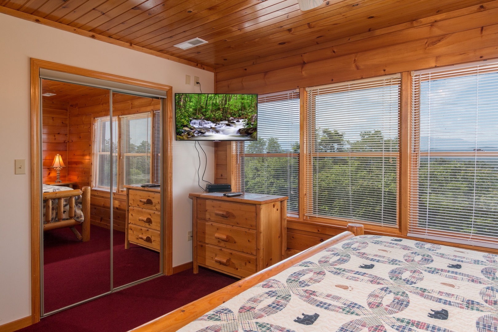 Dresser, TV, and closet in a bedroom at Moose Lodge, a 4 bedroom cabin rental located in Sevierville