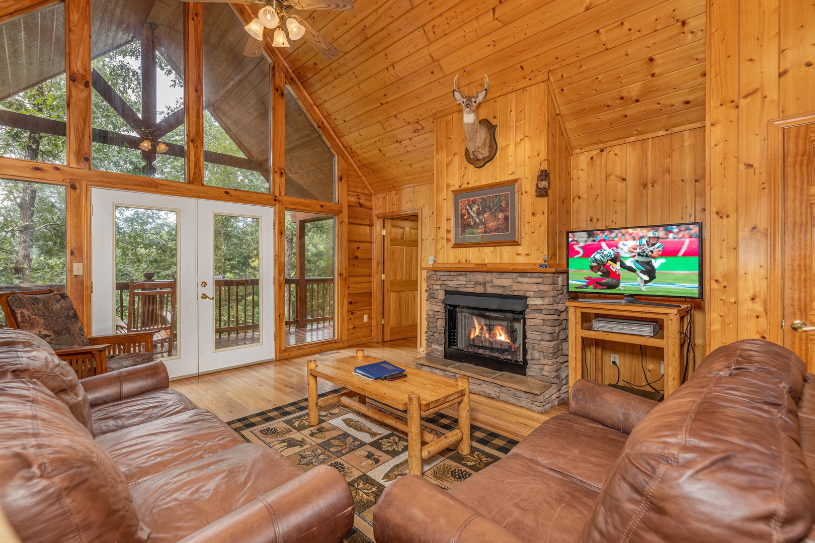 Living room with fireplace and TV at Wildlife Retreat, a 3 bedroom cabin rental located in Pigeon Forge