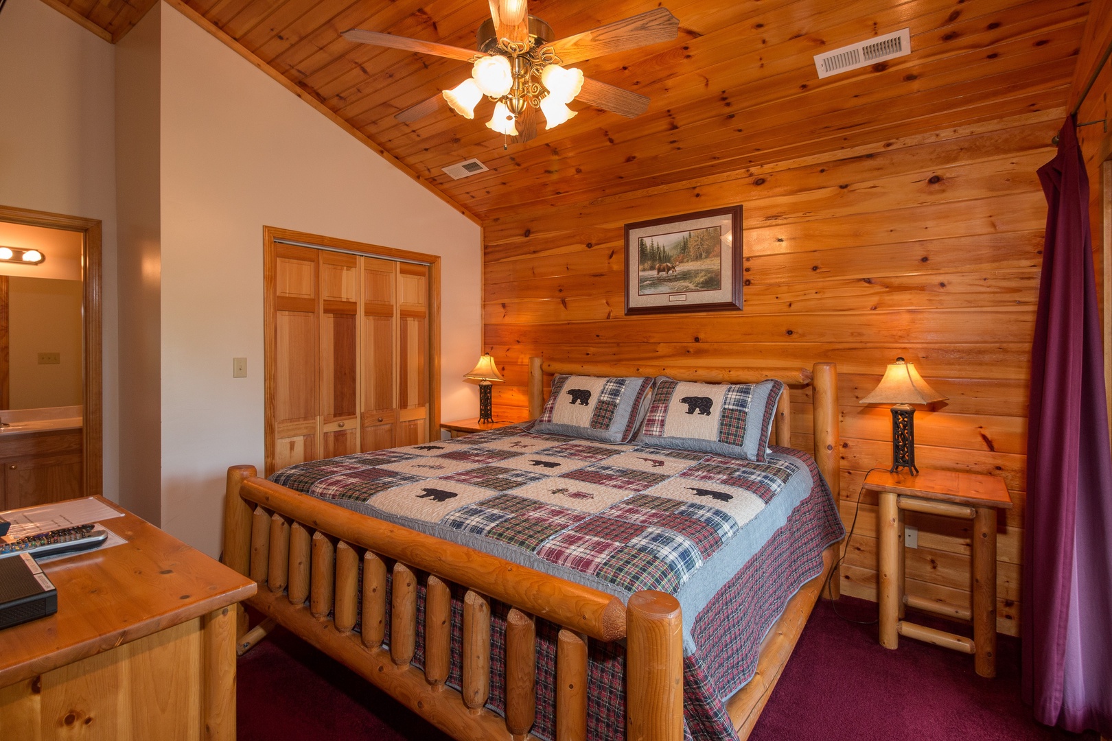 Bedroom with a king log bed, night stands, and lamps at Moose Lodge, a 4 bedroom cabin rental located in Sevierville