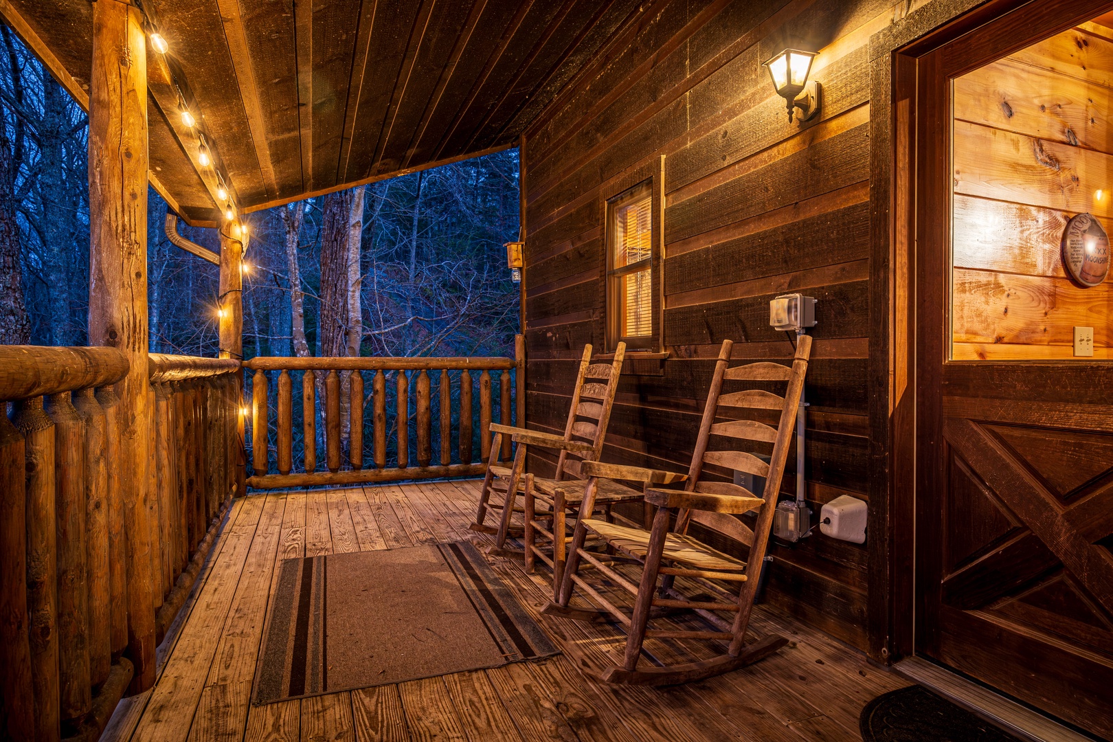 Rocking Charis at night on a covered deck at Moonshine Memories, a 2 bedroom cabin rental located in Gatlinburg