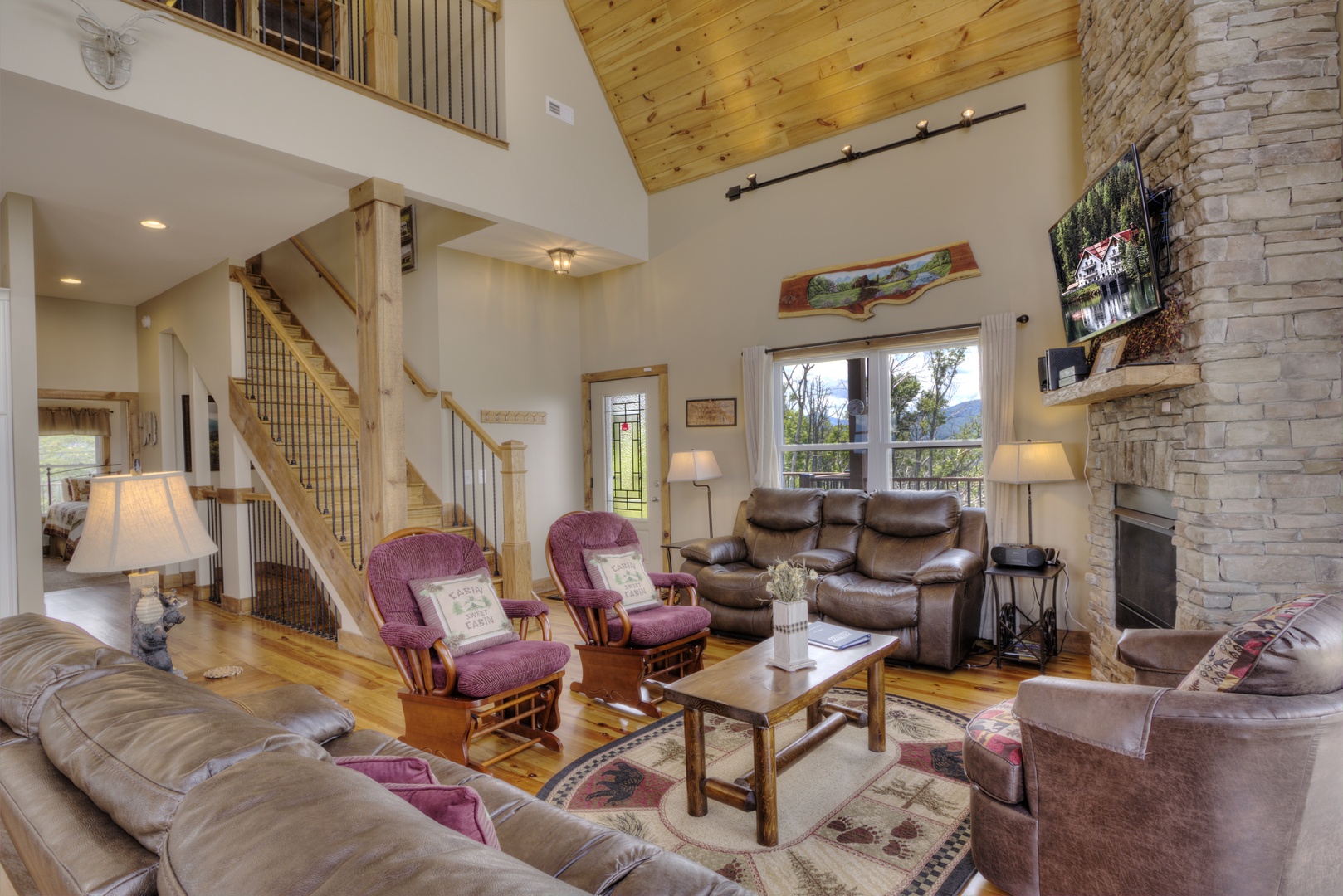 Family room with seating, flat screen, and fireplace at The Best View Lodge, a 5 bedroom cabin rental located in gatlinburg