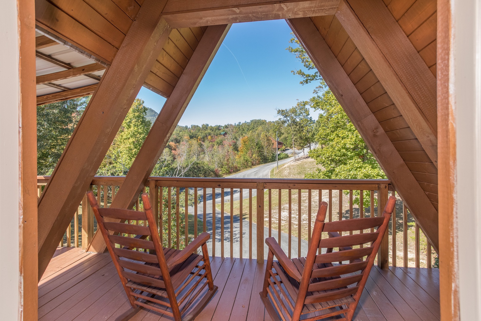 Rocking chairs on the upper deck at Living on Love, a 2 bedroom cabin rental located in Pigeon Forge