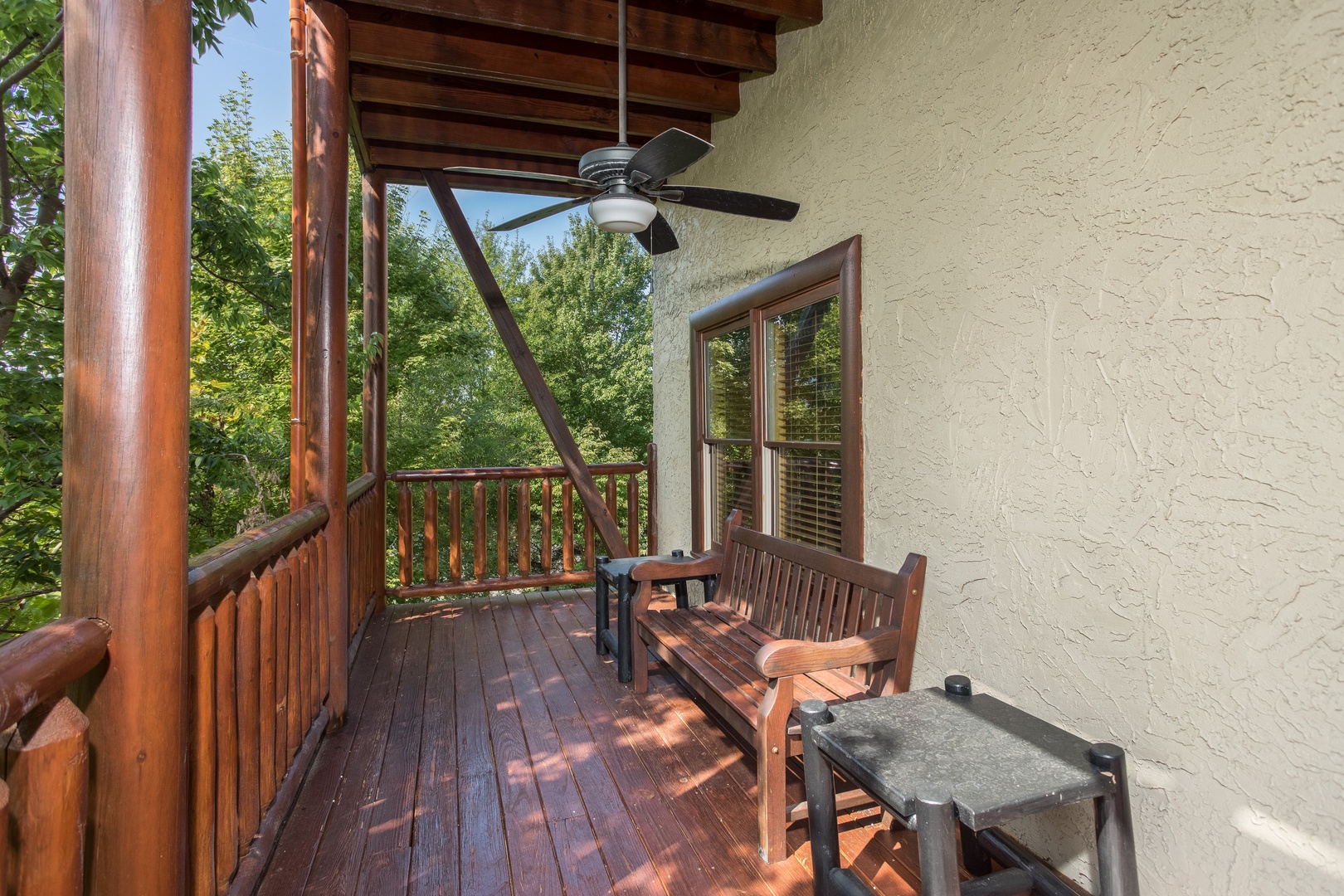 Bench on a deck at Graceland, a 4-bedroom cabin rental located in Pigeon Forge