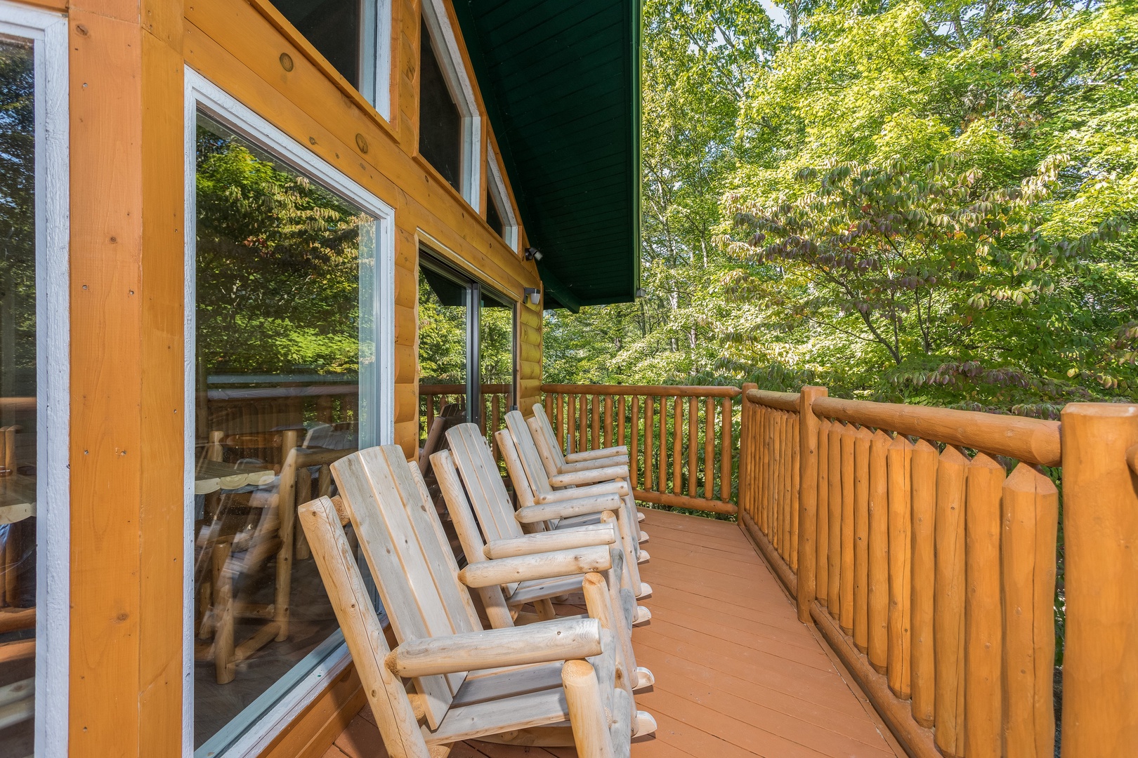 Upper deck with rocking chairs at Forever Country, a 3 bedroom cabin rental located in Pigeon Forge