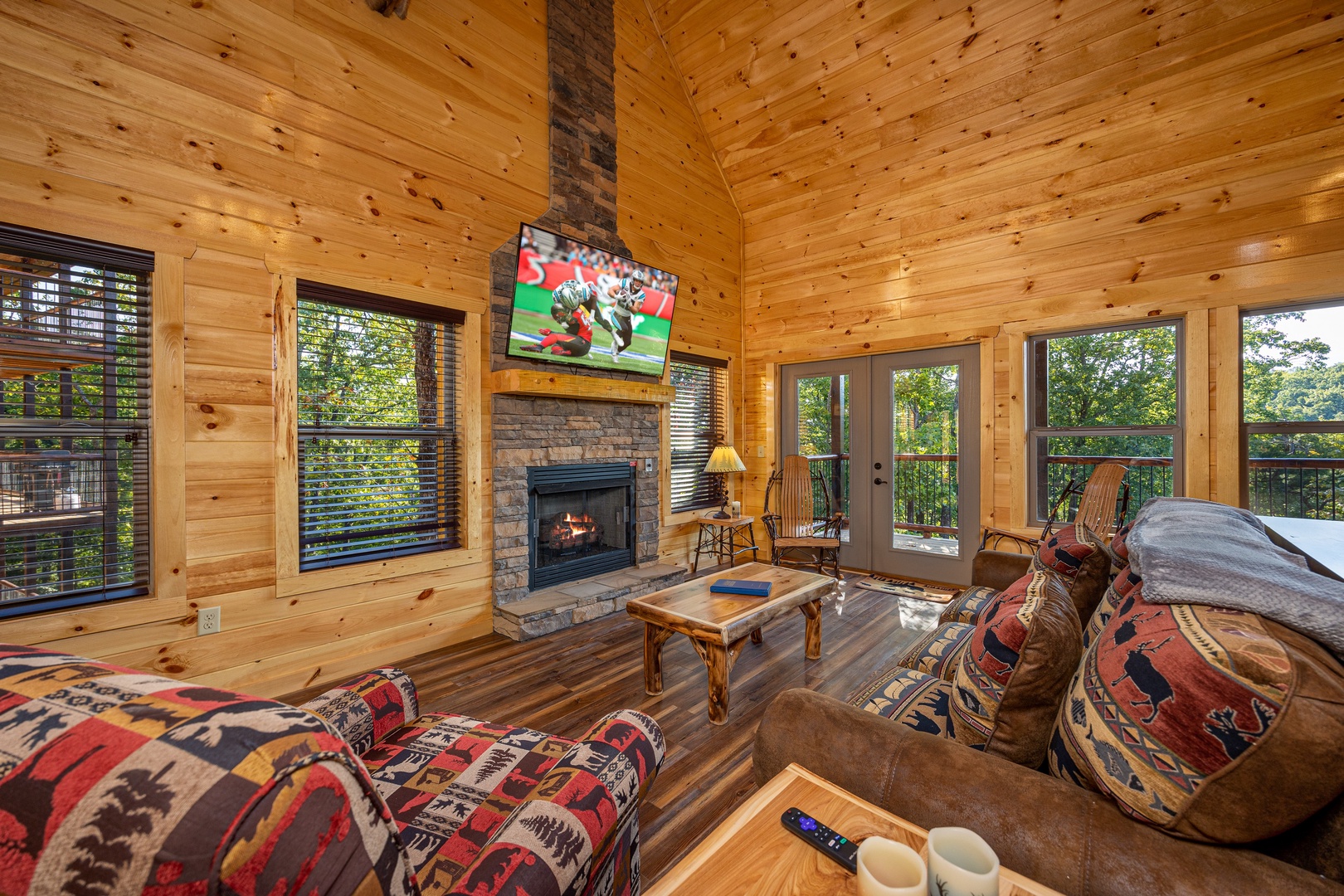 Living room with fireplace, flat screen, and seating at Make A Splash, a 2 bedroom cabin rental located in gatlinburg