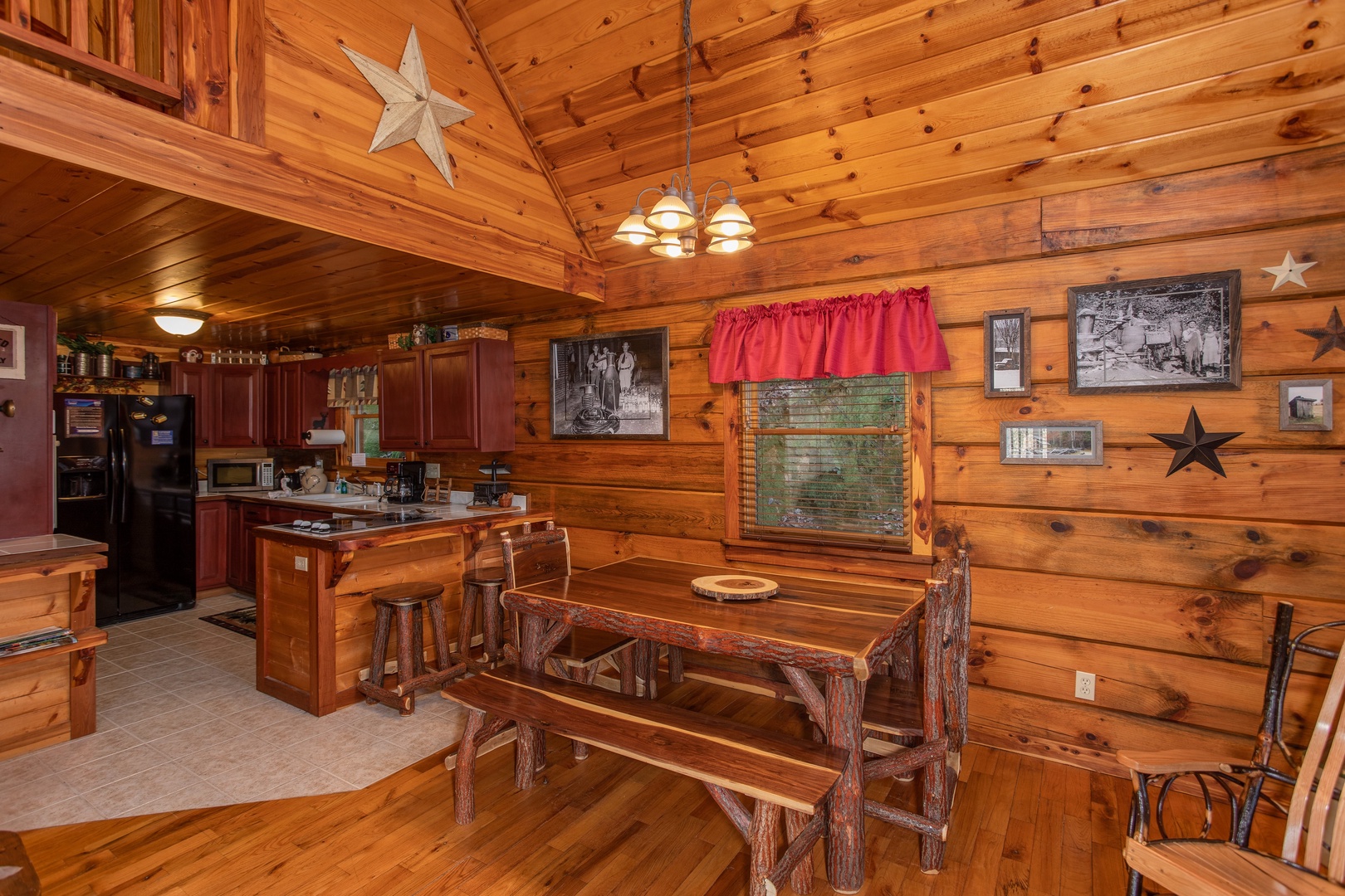 Picnic style dining table in the dining room at Moonshiner's Ridge, a 1-bedroom cabin rental located in Pigeon Forge