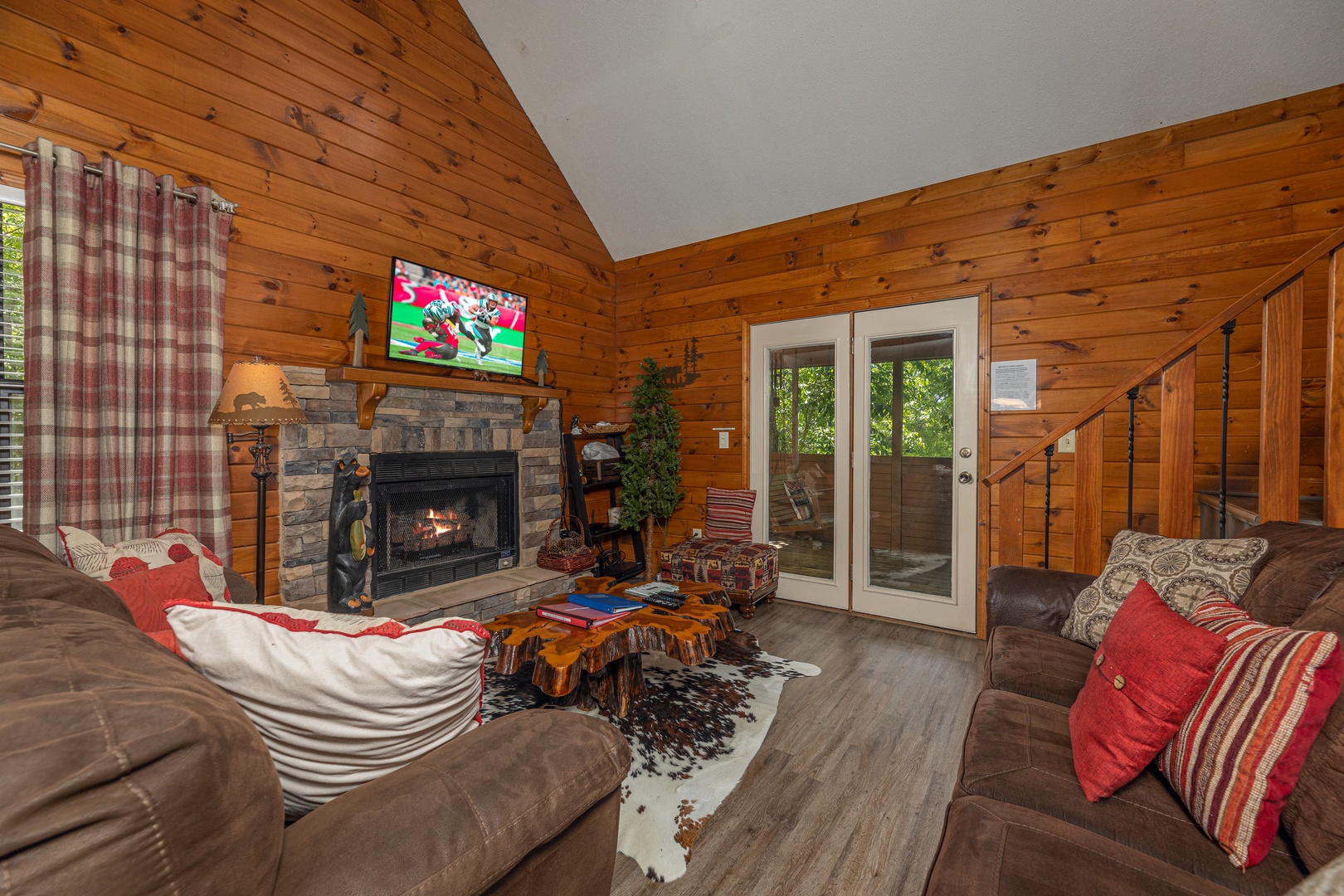 Living room with fireplace and TV at Magic Moments, a 2 bedroom cabin rental located in Pigeon Forge