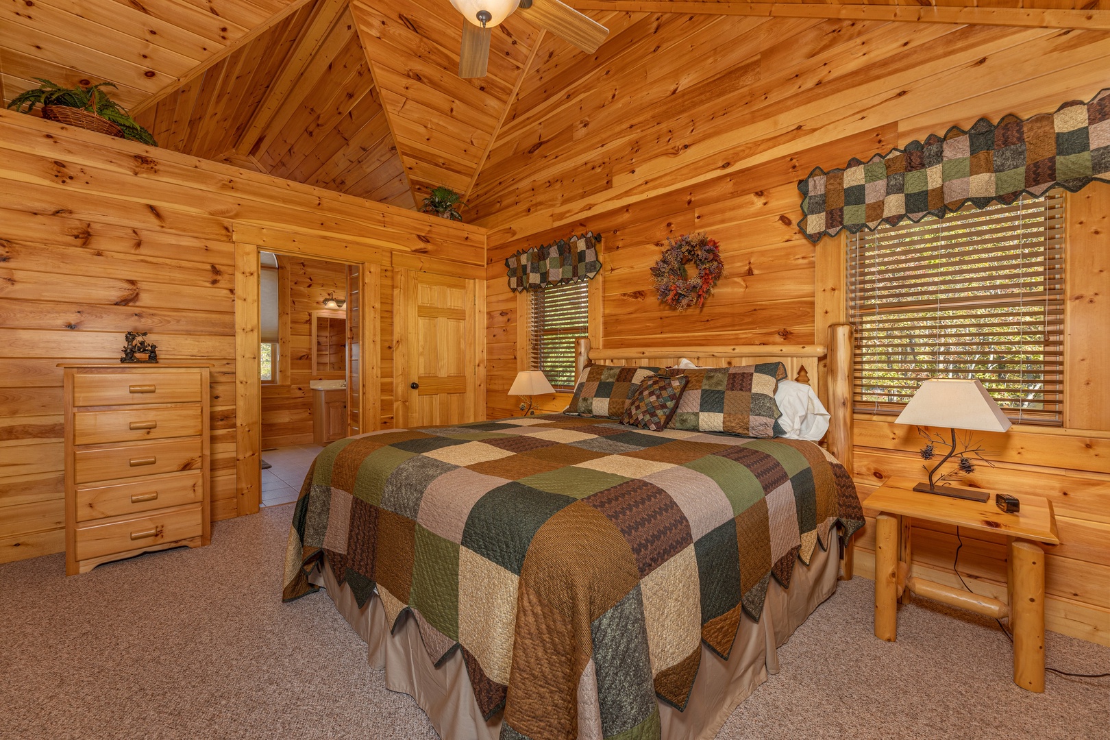 Bedroom with dresser, two night stands, and lamps at Sensational Views, a 3 bedroom cabin rental located in Gatlinburg