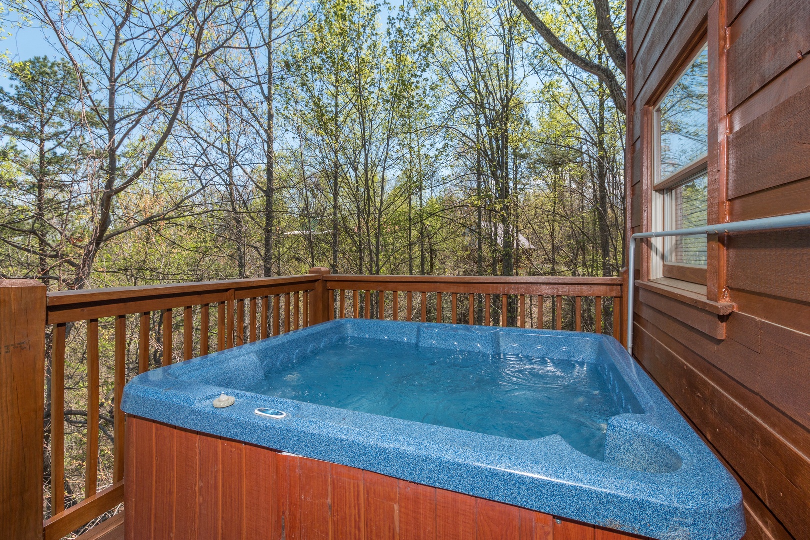 Hot tub on a deck at Lumber Jack Lodge, a 1 bedroom cabin rental located in Gatlinburg