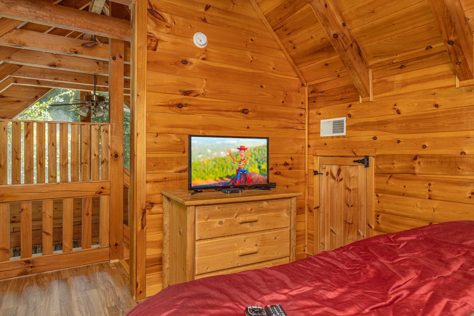 Bedroom with a dresser and TV at Honeymoon in Gatlinburg, a 1 bedroom cabin rental located in Gatlinburg