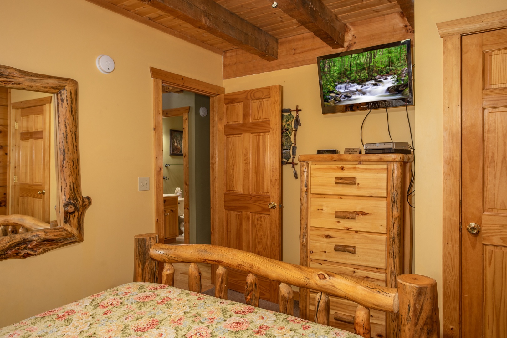 Bedroom with a dresser and TV at Alpine Romance, a 2 bedroom cabin rental located in Pigeon Forge
