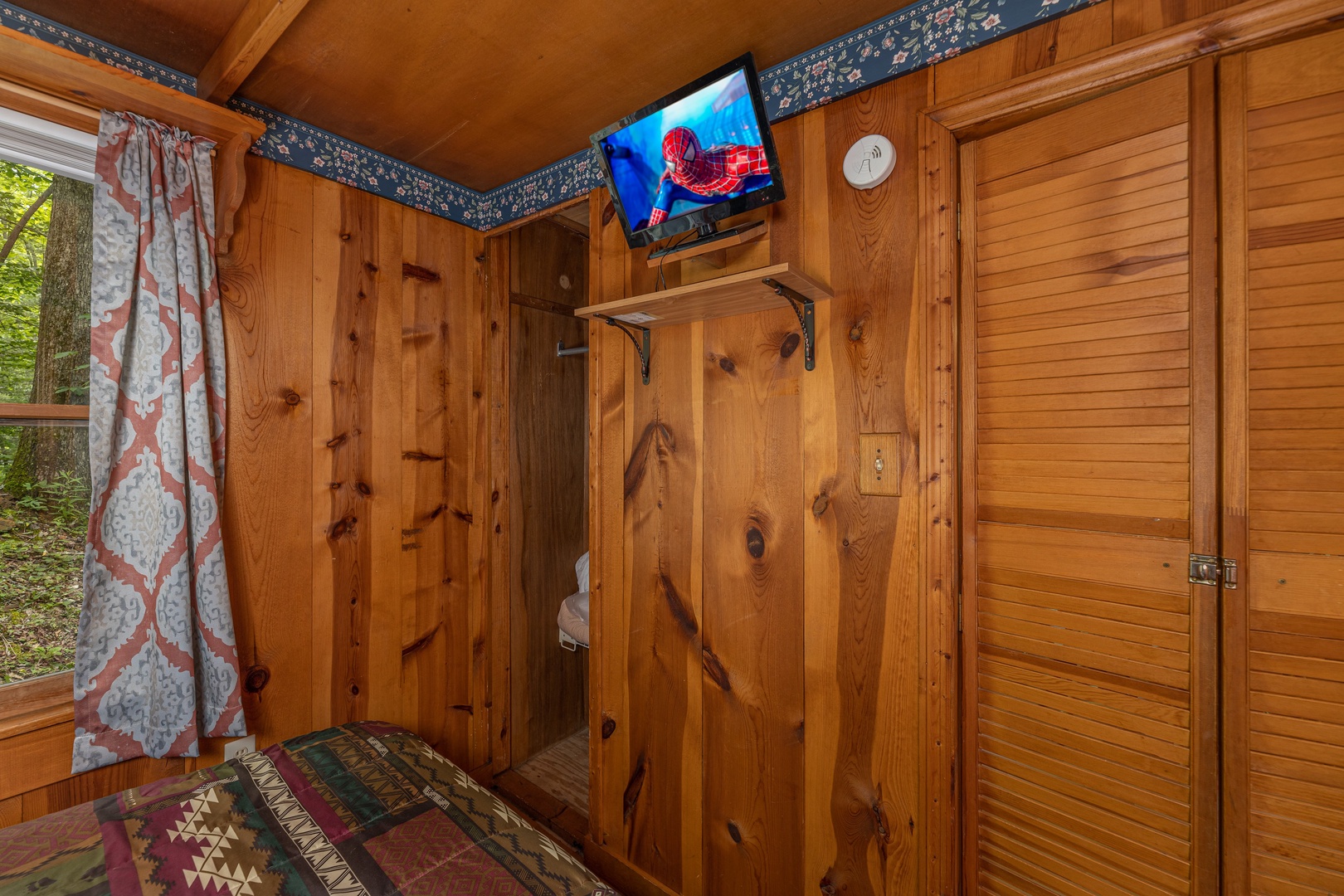 TV and closet in a bedroom at Heavenly Hideaway, a 2-bedroom cabin rental located in Gatlinburg