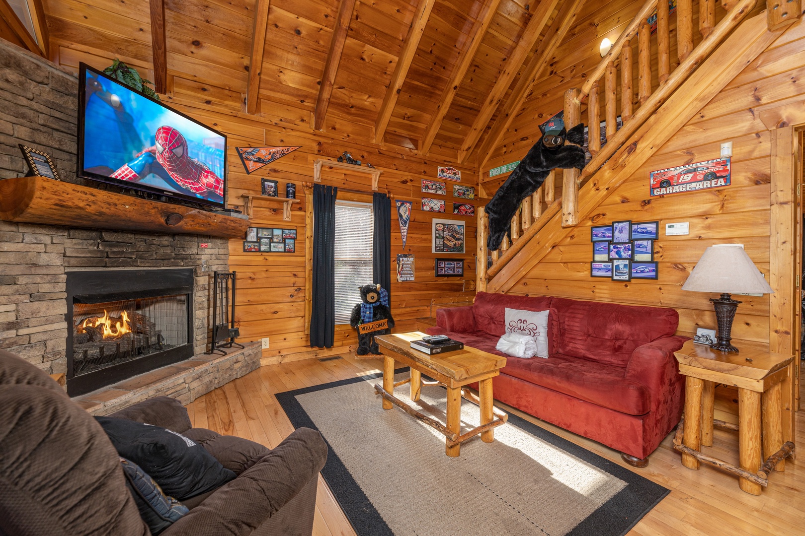 Fireplace and TV in a living room at Nascar Nation, a 2 bedroom cabin rental located in Pigeon Forge
