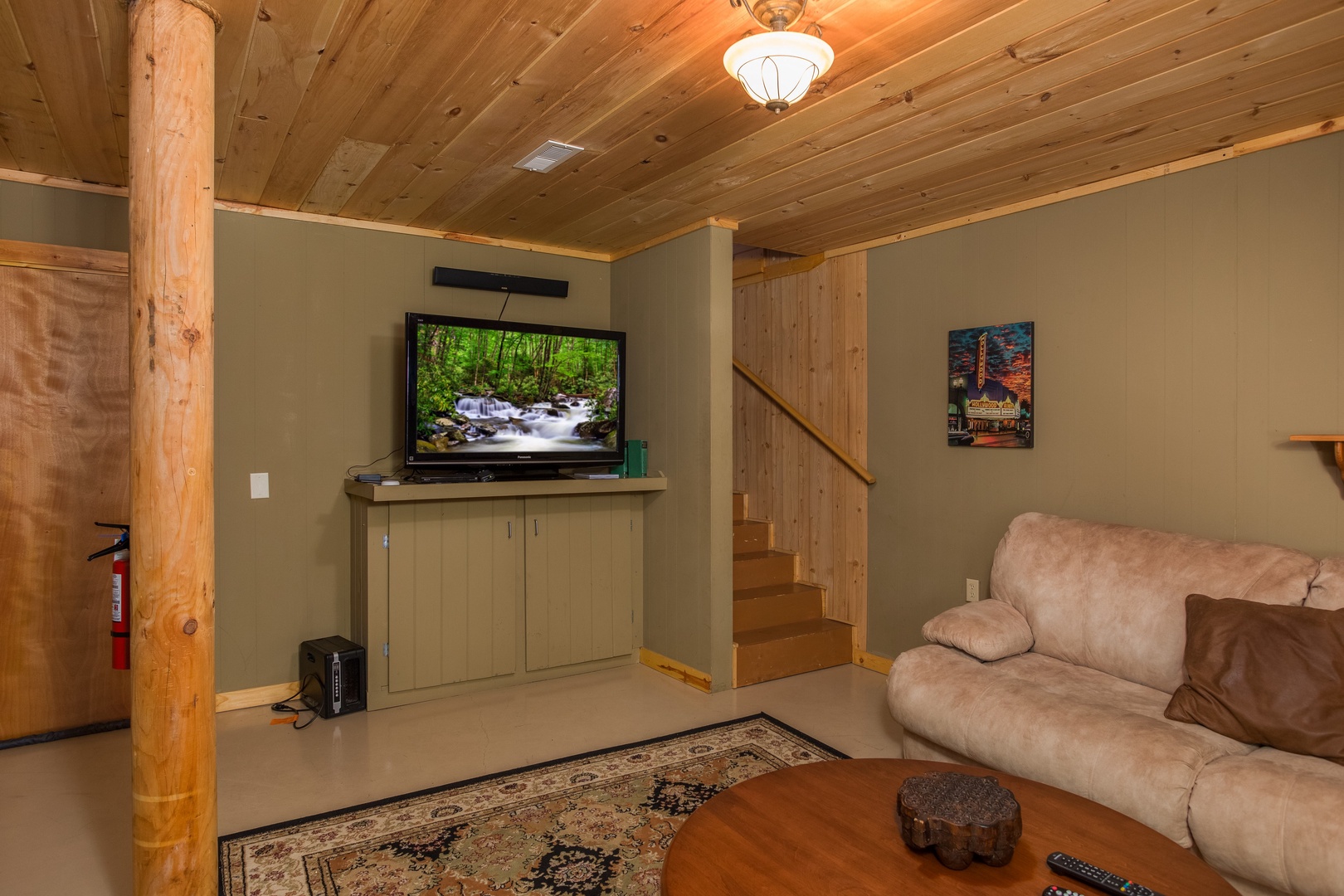 TV in the lower living room at Laid Back, a 2 bedroom cabin rental located in Pigeon Forge