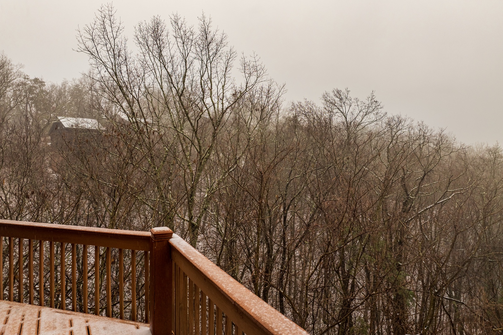 Snowy open deck at Lazy Bear Retreat, a 4 bedroom cabin rental located in Pigeon Forge