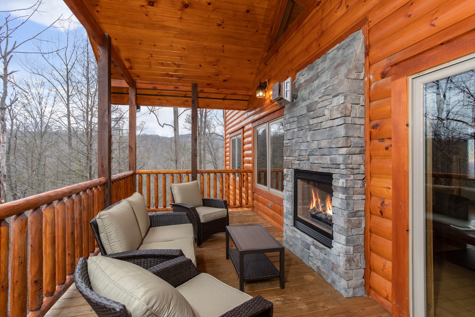 Outdoor seating area with see through fireplace at Happy Bear's Hideaway, a 2 bedroom cabin rental located in Gatlinburg