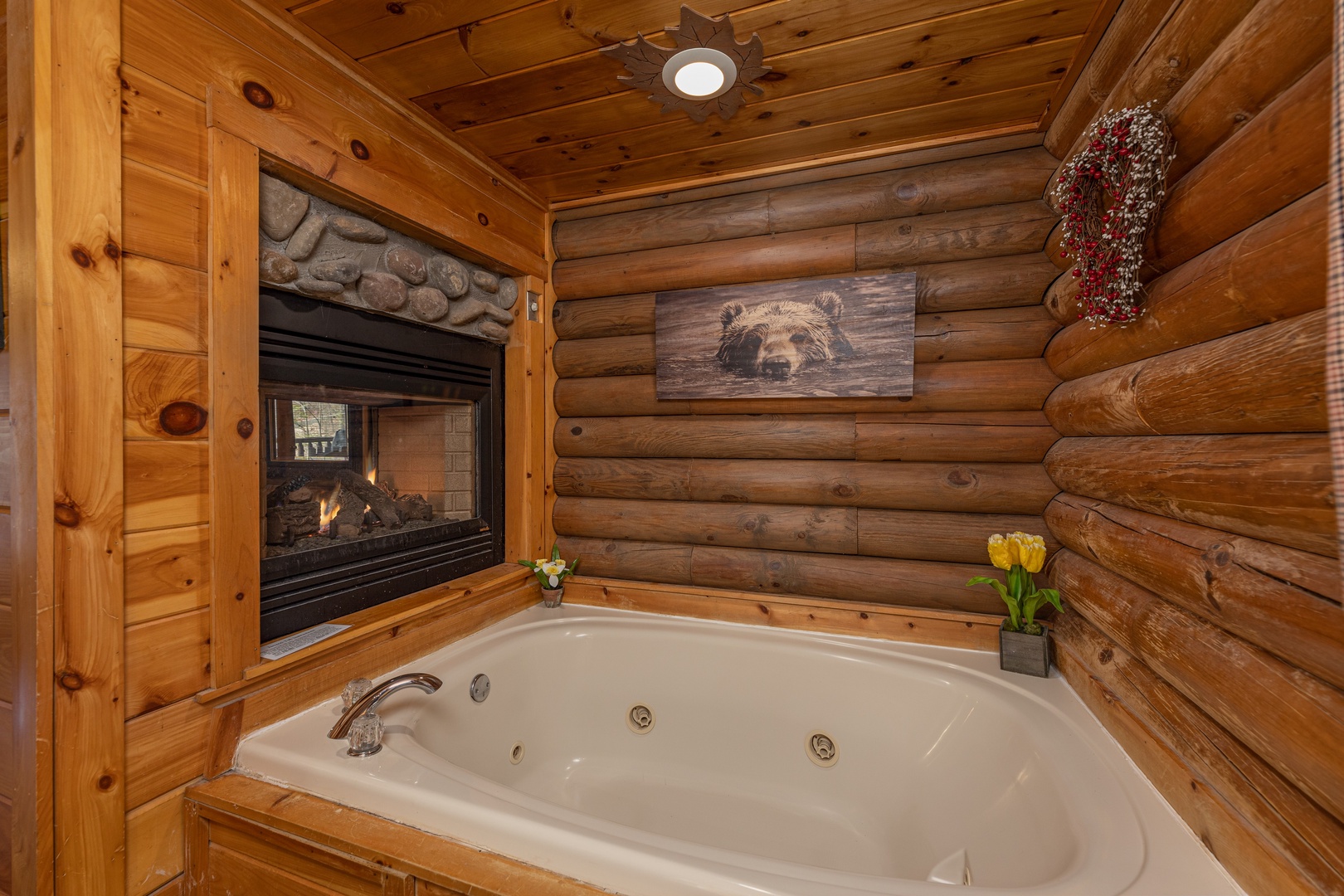 Jacuzzi and a double-sided fireplace at A Lover's Secret, a 1 bedroom cabin rental located in Gatlinburg