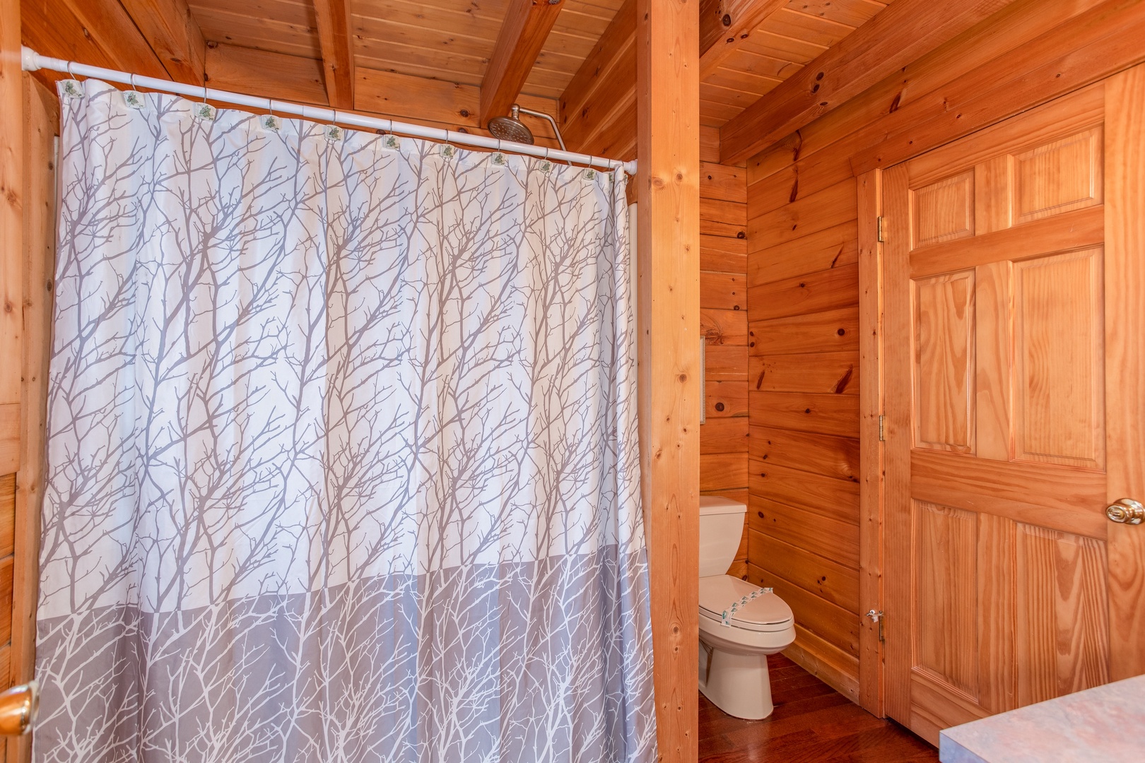 Bathroom with a tub and shower at Enchanted Evening, a 1-bedroom cabin rental located in Pigeon Forge