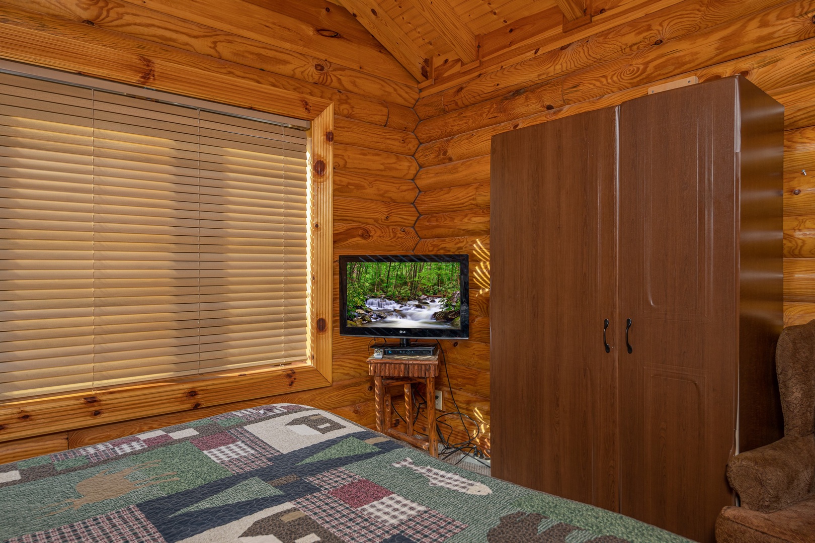 TV and armoire in a bedroom at Gone Fishin', a 2-bedroom cabin rental located in Pigeon Forge