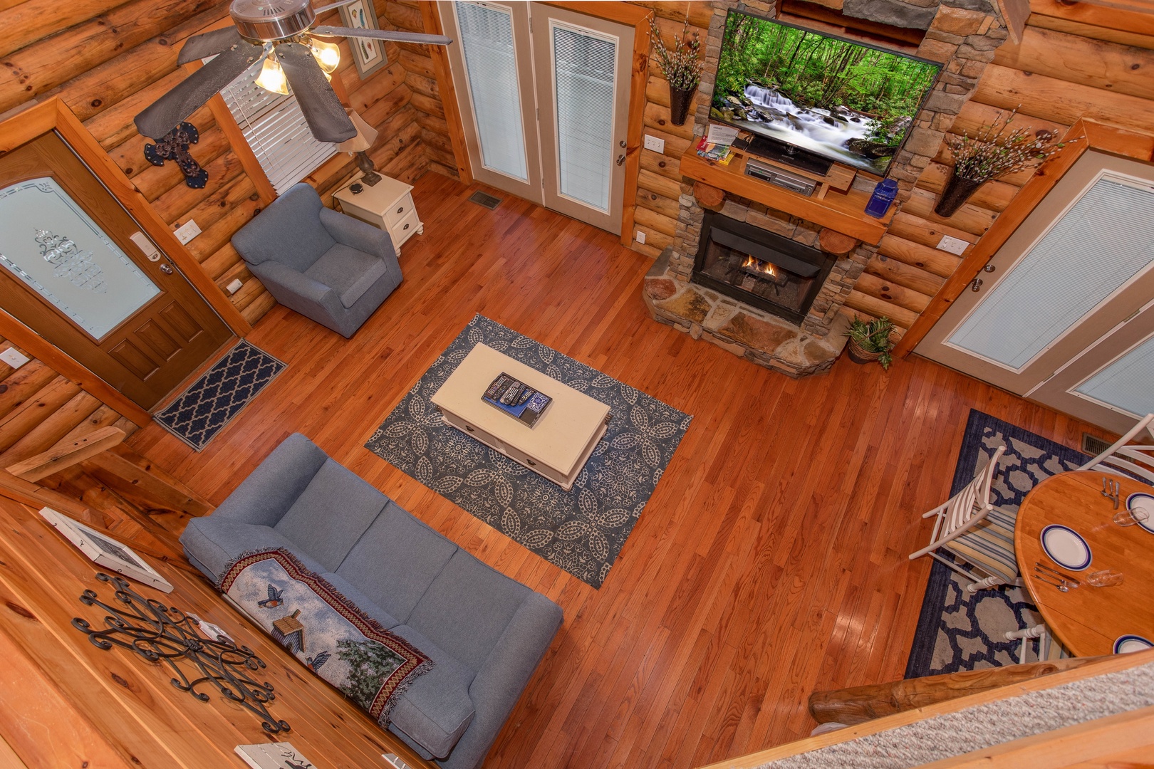 overhead view of the living room with stone fireplace and television at alpine something blue a 1 bedroom cabin rental located in pigeon forge