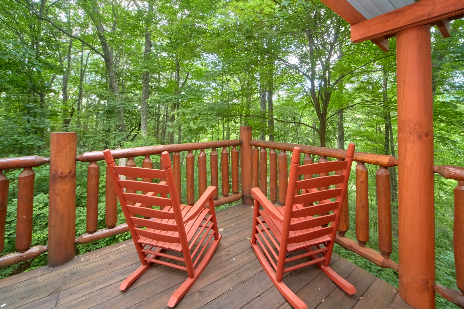 Rocking chairs with a wooded view at Love Struck, a 1 bedroom cabin rental located in Pigeon Forge