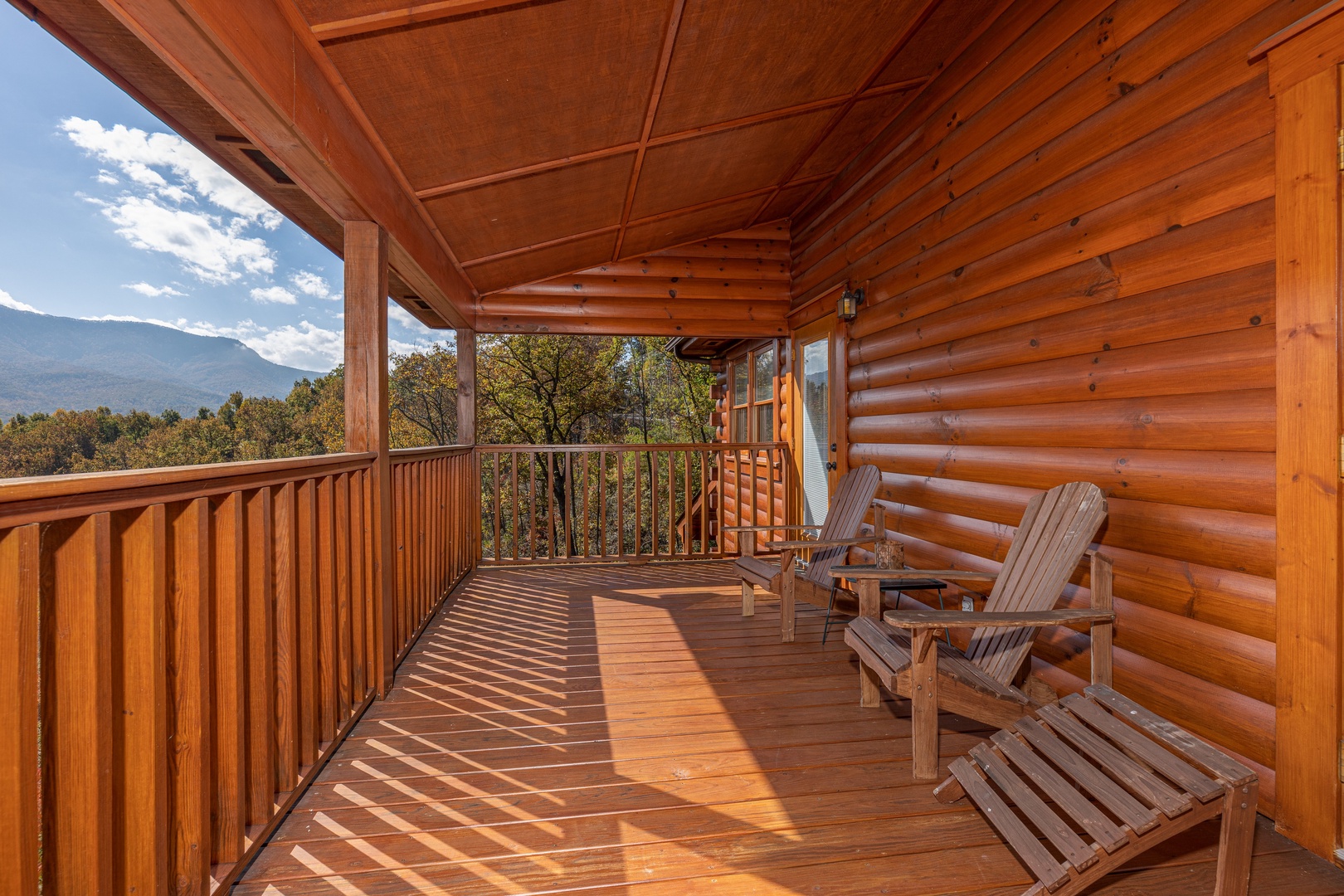 Covered deck with mountain views at Sensational Views, a 3 bedroom cabin rental located in Gatlinburg