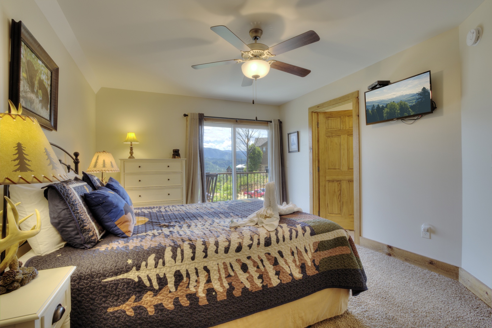 Bedroom with deck entry at The Best View Lodge, a 5 bedroom cabin rental located in gatlinburg