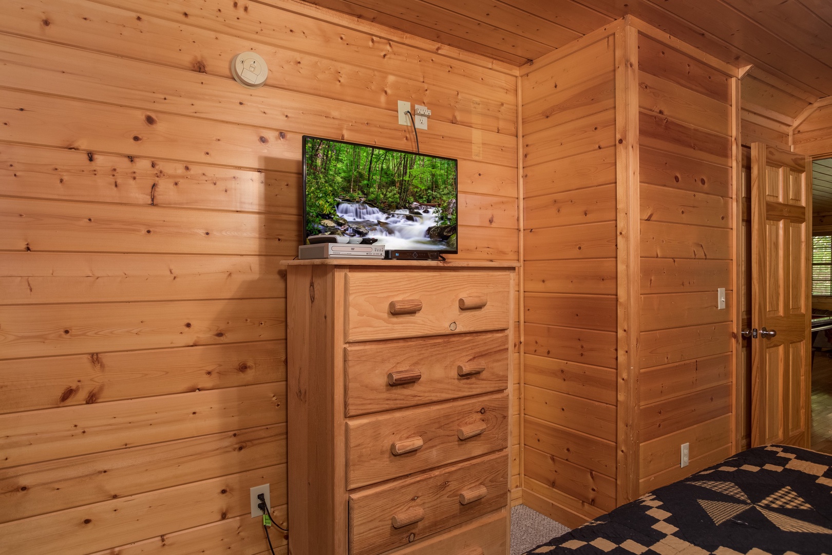 Dresser and TV in a bedroom at Kick Back & Relax! A 4 bedroom cabin rental located in Pigeon Forge