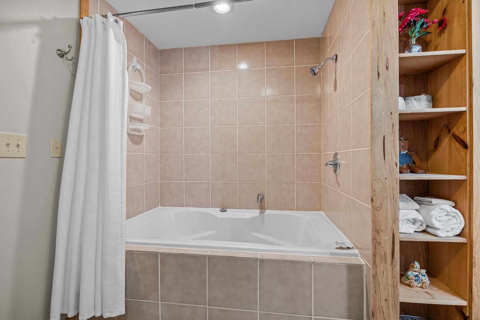 Soaker tub and shower combo at Brink of Heaven, a 2 bedroom cabin rental located in Gatlinburg