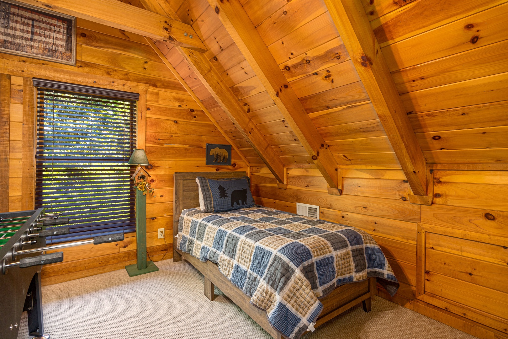 Twin bed in the loft at Bear Feet Retreat, a 1 bedroom cabin rental located in pigeon forge