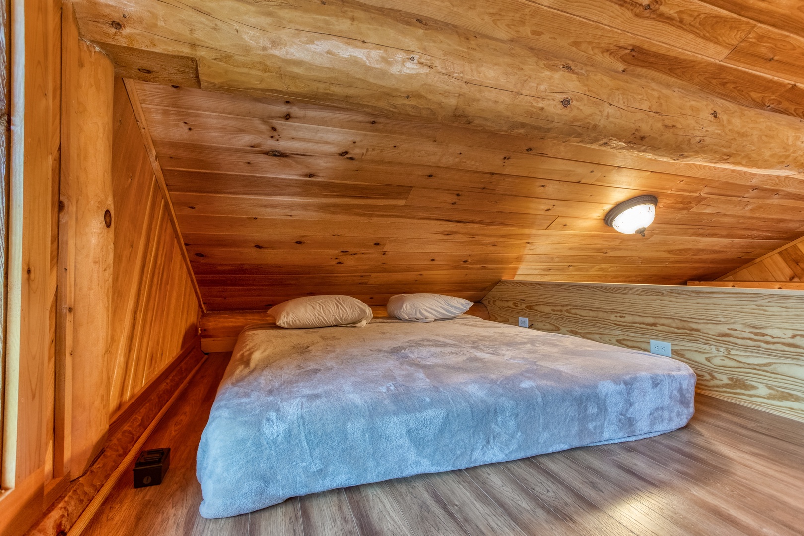King bed in the sleeping loft off the first bedroom at Great View Lodge, a 5-bedroom cabin rental located in Pigeon Forge
