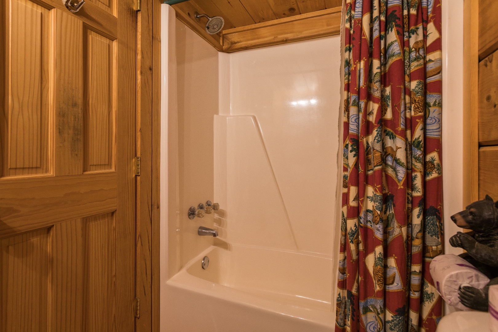 Bathroom with a tub and shower at Boogie Bear, a 1-bedroom cabin rental located in Gatlinburg