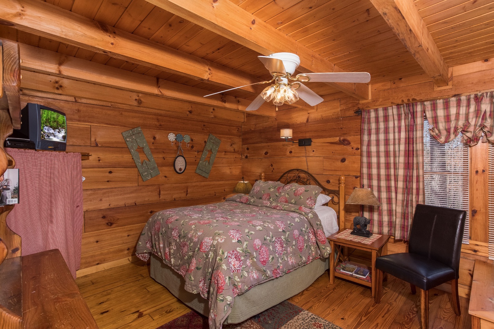 Bedroom with a queen-sized bed and television at Cloud 9, a 1-bedroom cabin rental located in Pigeon Forge