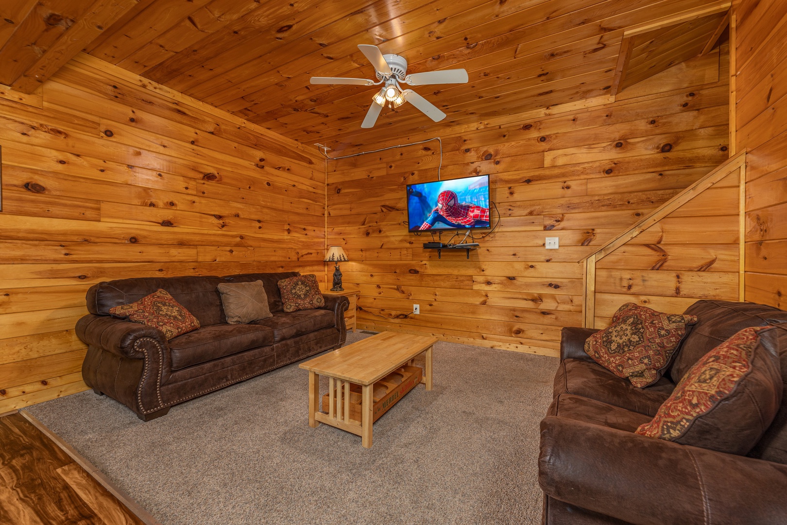 Two sofas and a TV in the game room at Family Getaway, a 4 bedroom cabin rental located in Pigeon Forge