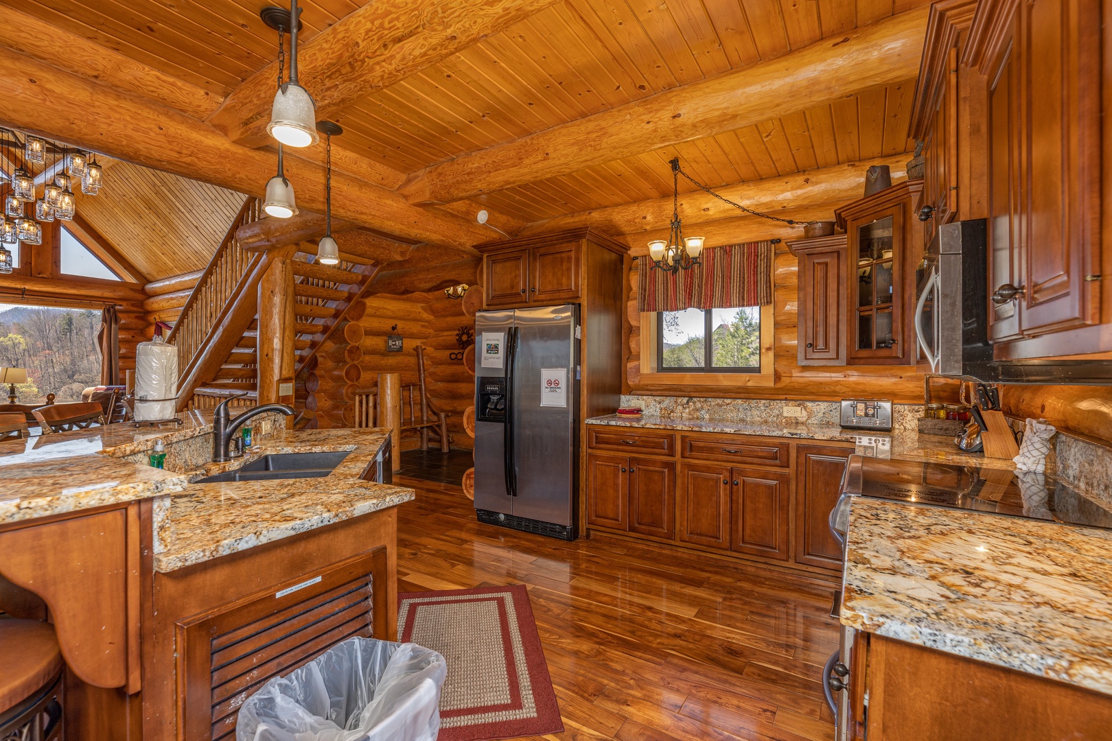 Kitchen with granite counters and stainless appliances at God's Country, a 4 bedroom cabin rental located in Pigeon Forge