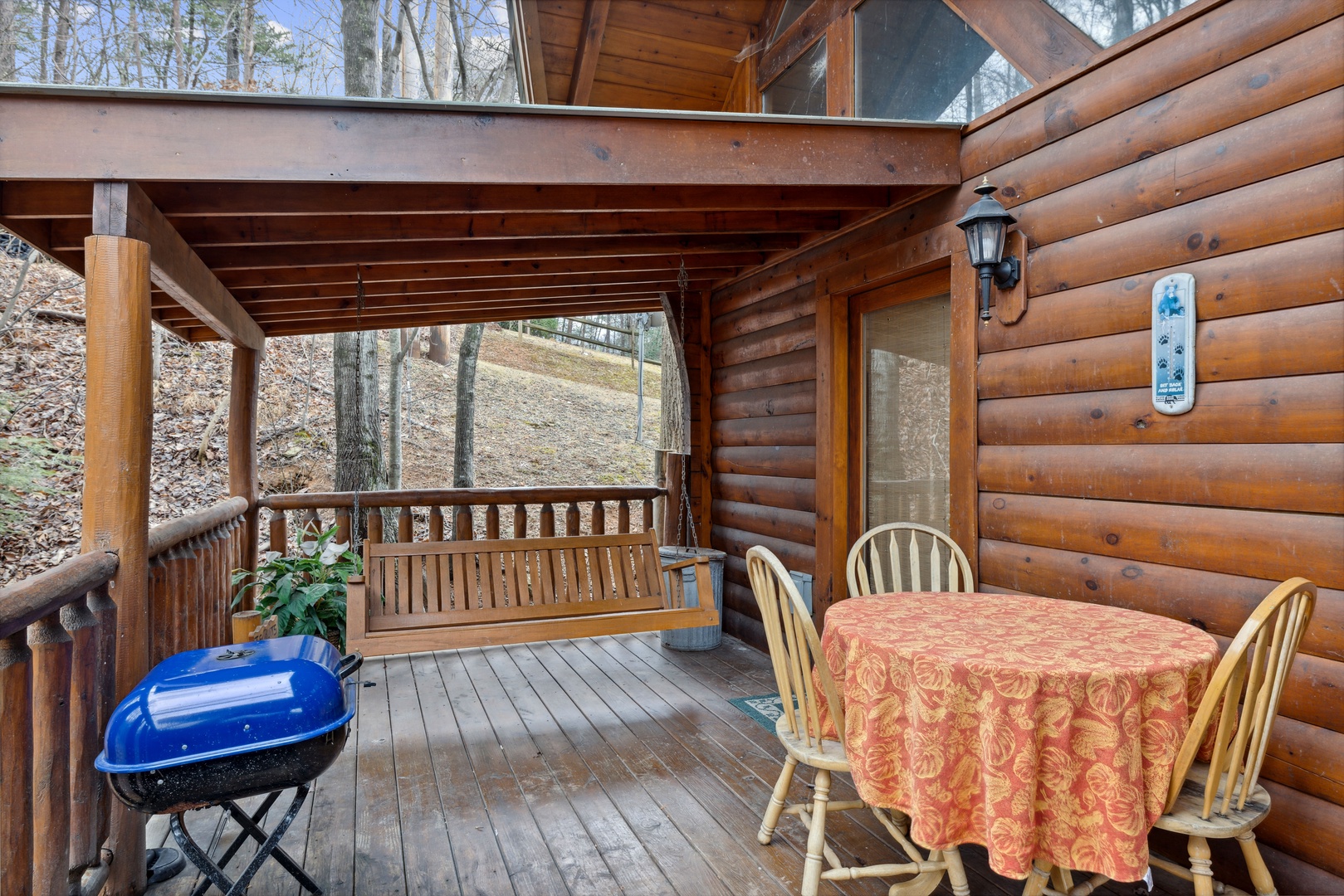 Dining space for three on the deck at Dreams Do Come True, a 1-bedroom cabin rental located in Pigeon Forge