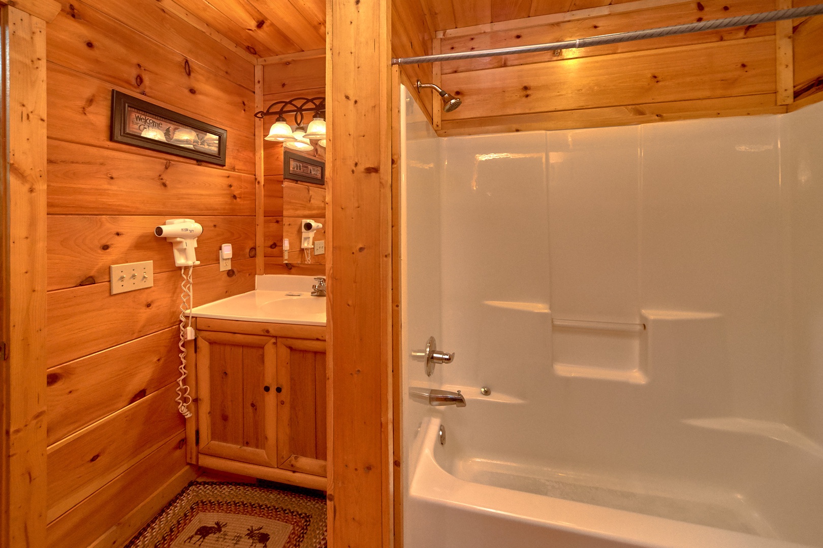 Bathroom with a tub and shower at Love Struck, a 1 bedroom cabin rental located in Pigeon Forge