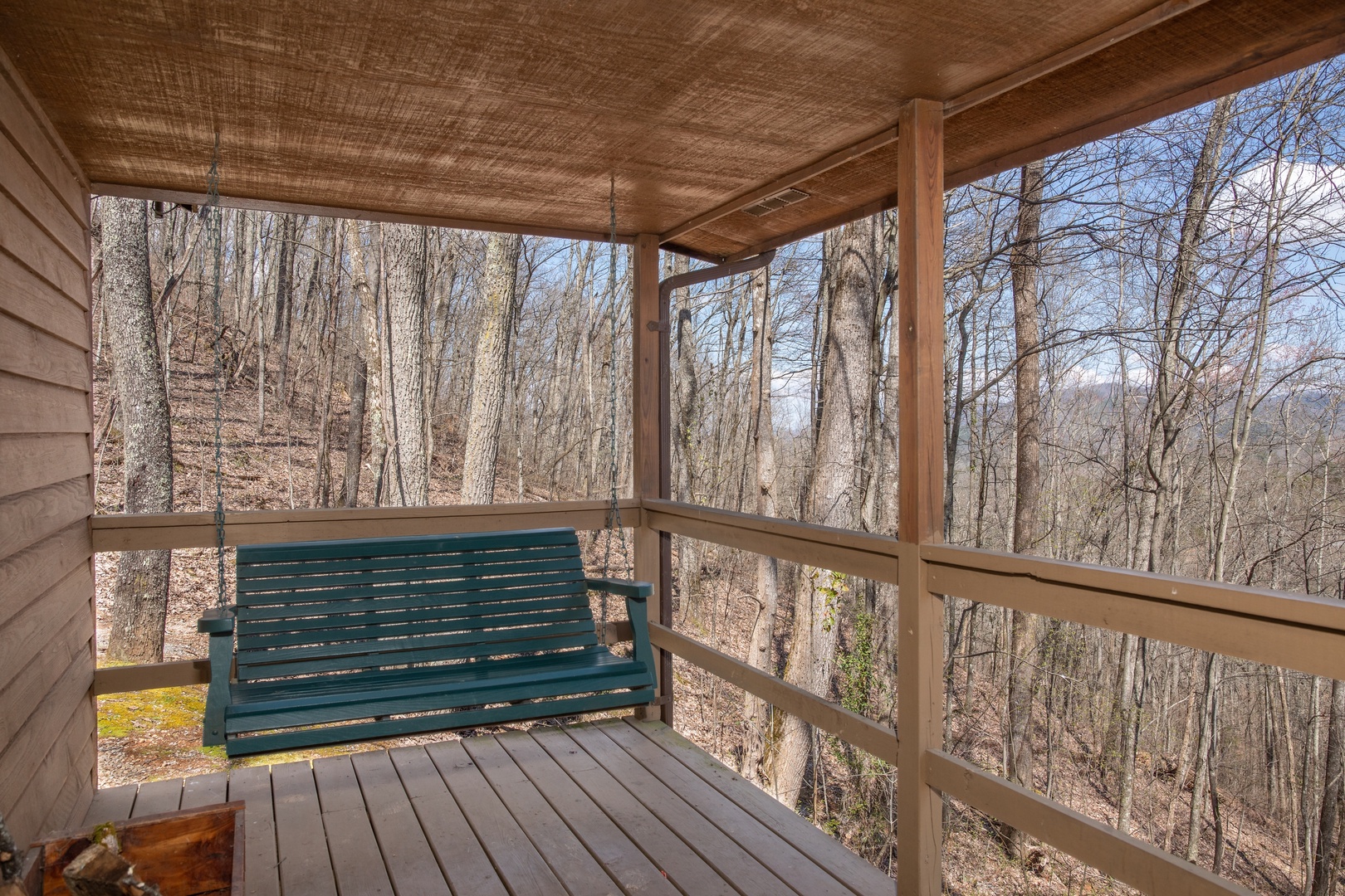 Porch swing and winter mountain views at Hideaway, a 1 bedroom cabin rental located in Pigeon Forge